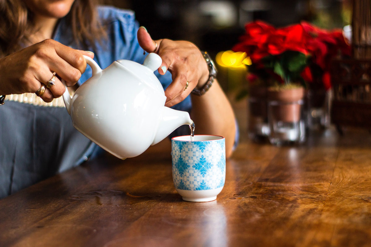 Person pouring tea