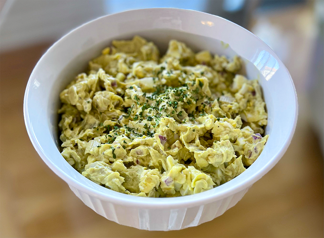 Chunky artichoke egg salad in a white bowl