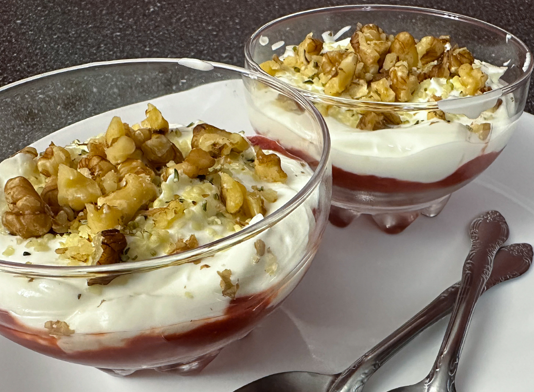 Prime Fertility Yogurt Parfaits in glass cups with strawberry base and topped with walnuts